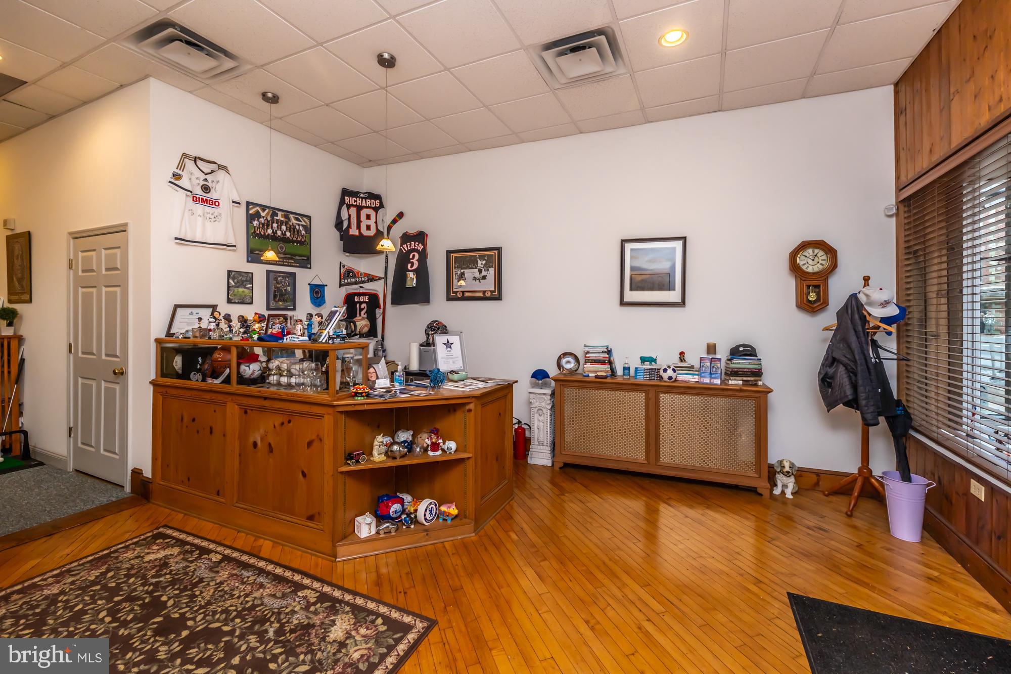 107 West State Street Kennett Square, PA 19348 - Photo 12 of 52 a living room with lots of furniture and wooden floor