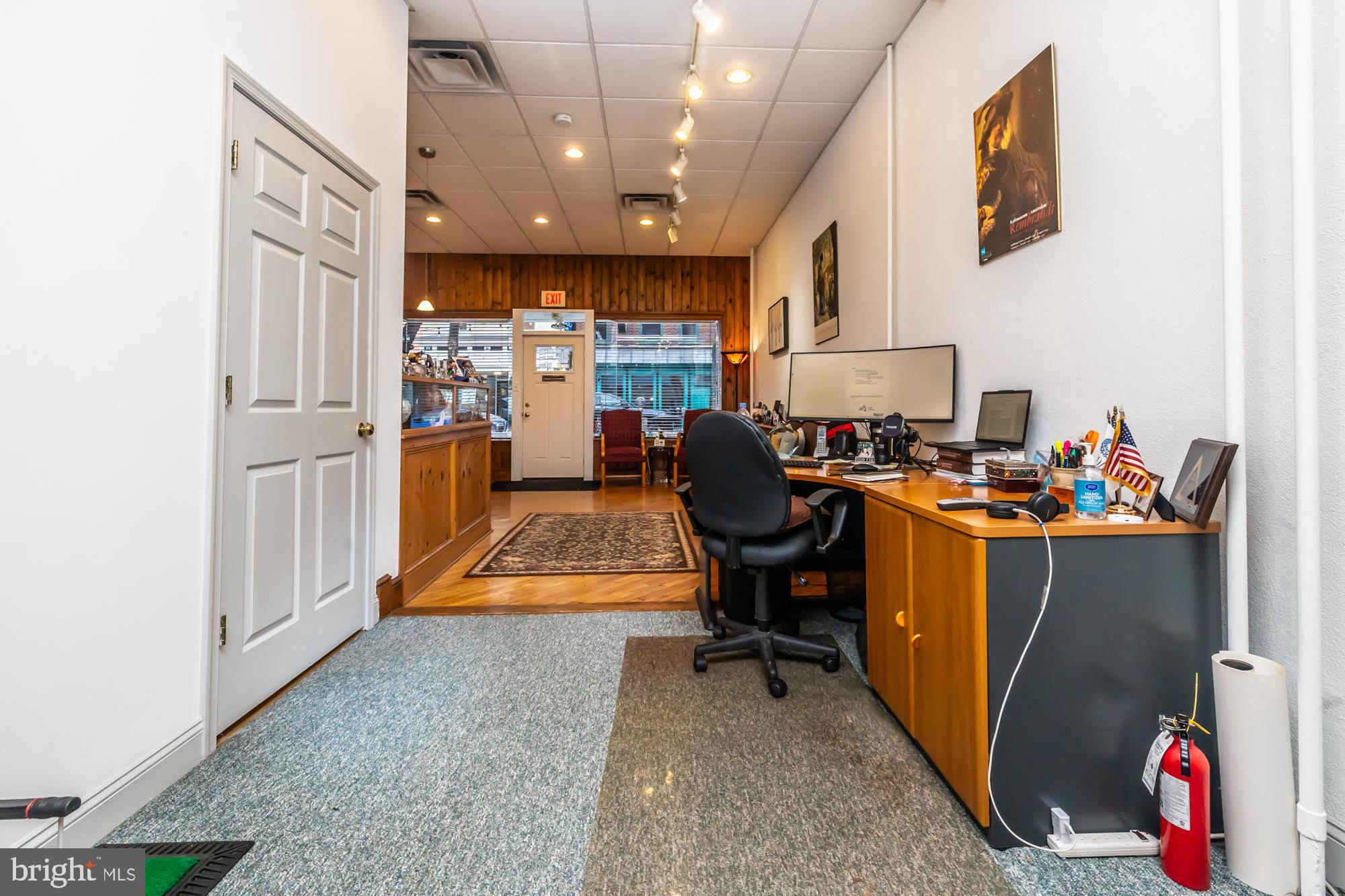 107 West State Street Kennett Square, PA 19348 - Photo 16 of 52 a room with furniture a rug and a fireplace