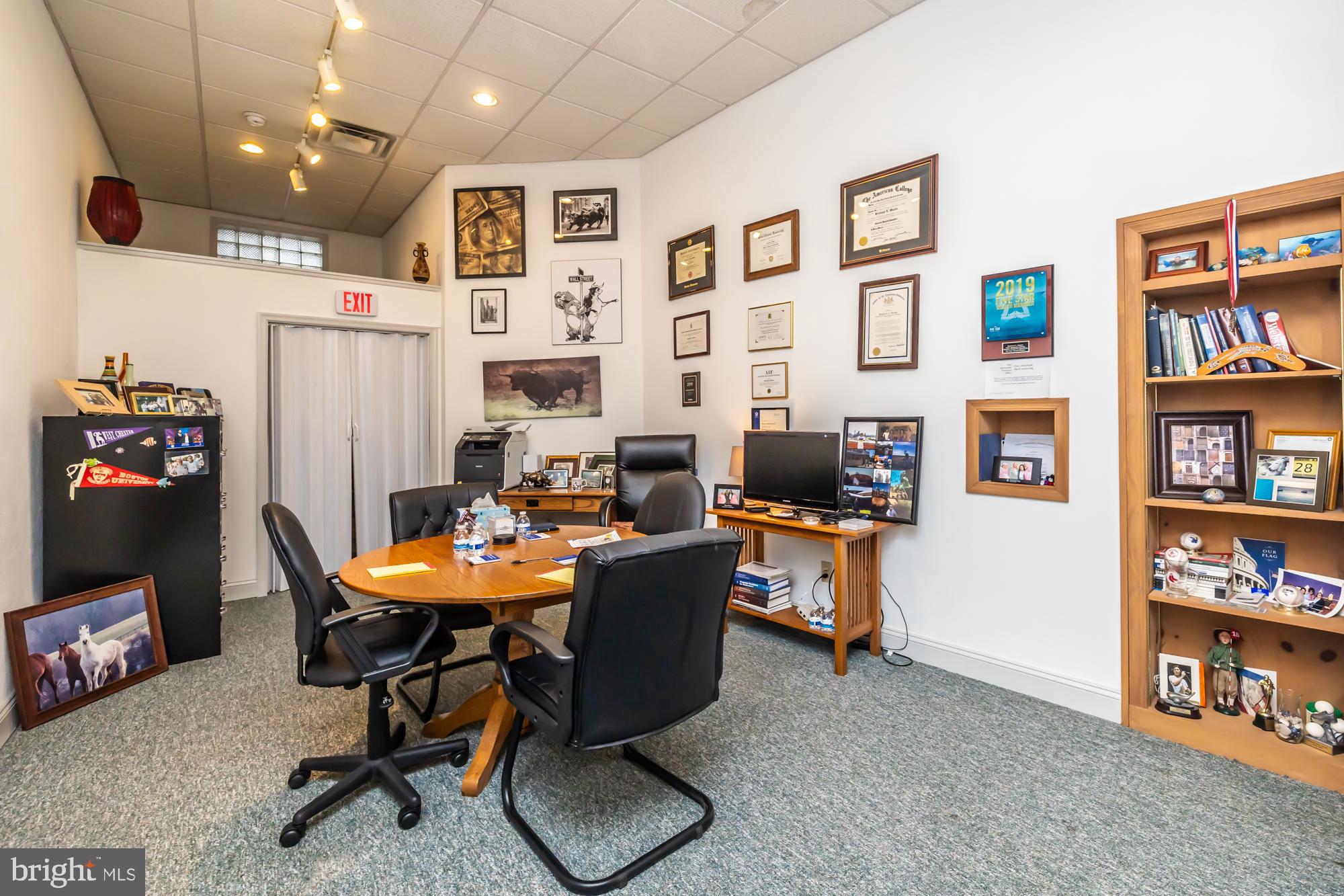 107 West State Street Kennett Square, PA 19348 - Photo 17 of 52 a workspace with furniture and a book shelf