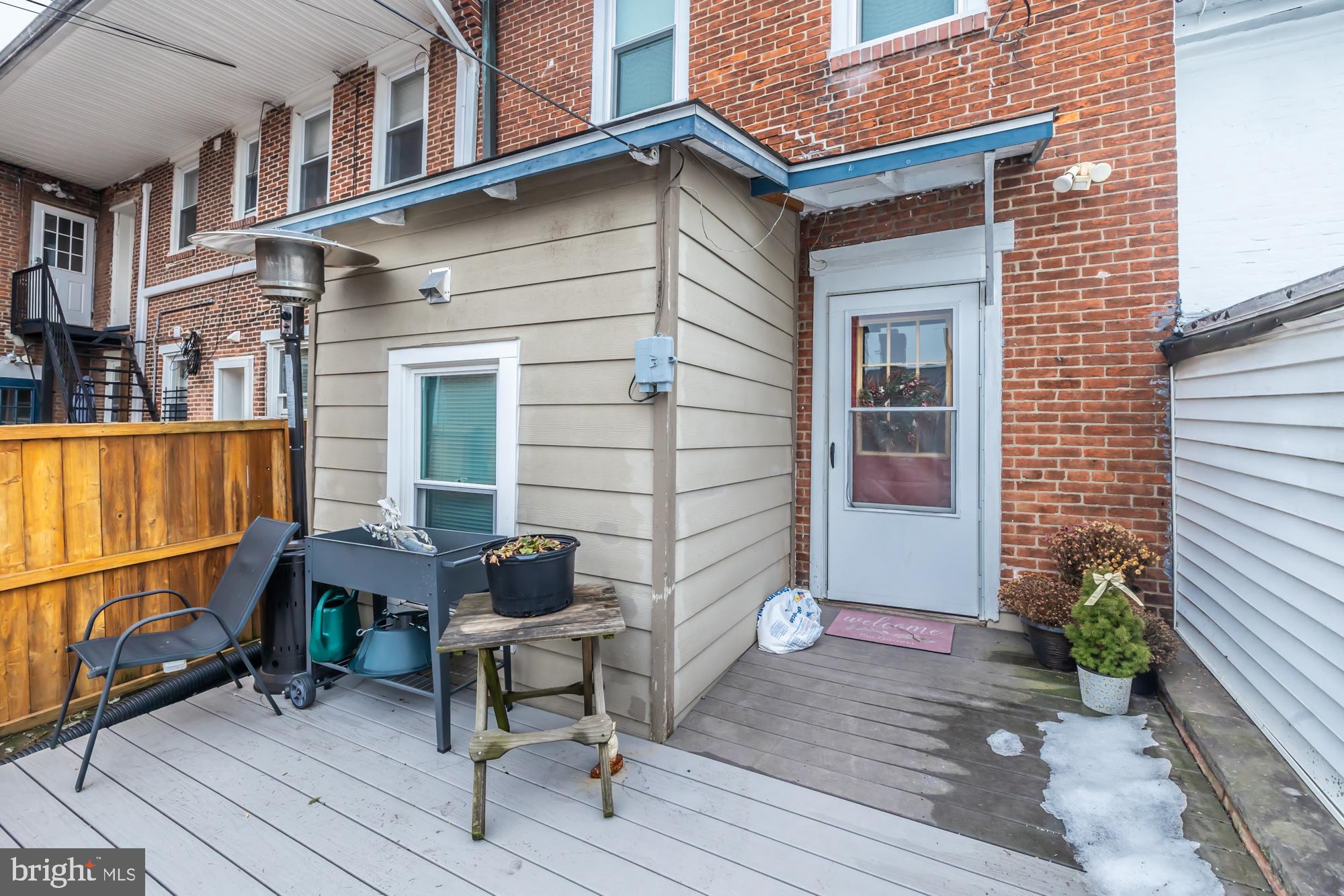 107 West State Street Kennett Square, PA 19348 - Photo 29 of 52 a brick building with a bench in front of it