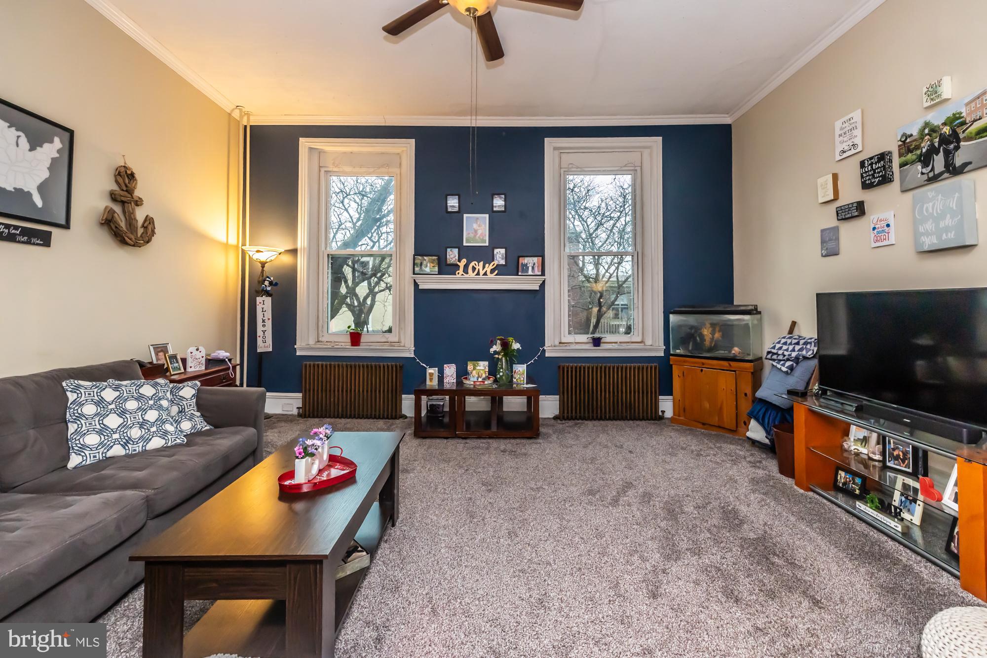 107 West State Street Kennett Square, PA 19348 - Photo 31 of 52 a living room with furniture and a flat screen tv