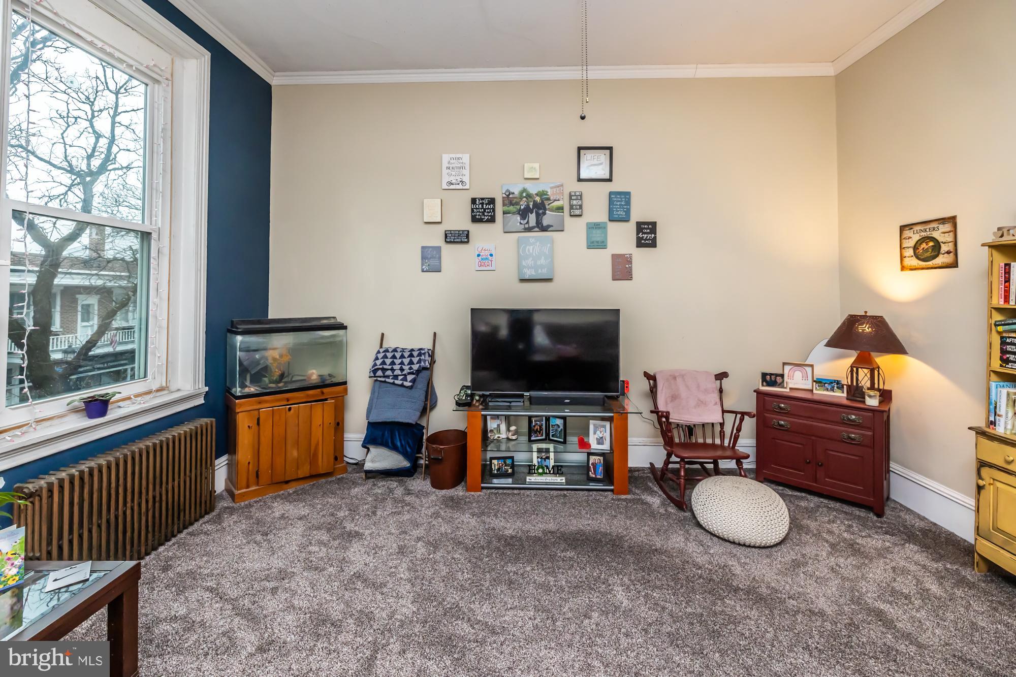 107 West State Street Kennett Square, PA 19348 - Photo 34 of 52 a living room with furniture and a flat screen tv