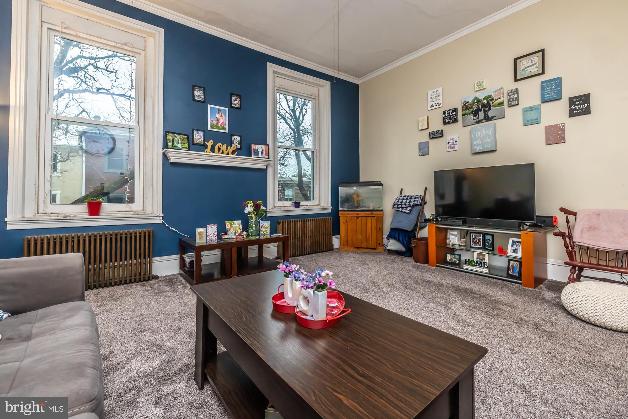 107 West State Street Kennett Square, PA 19348 - Photo 35 of 52 a living room with furniture and a flat screen tv