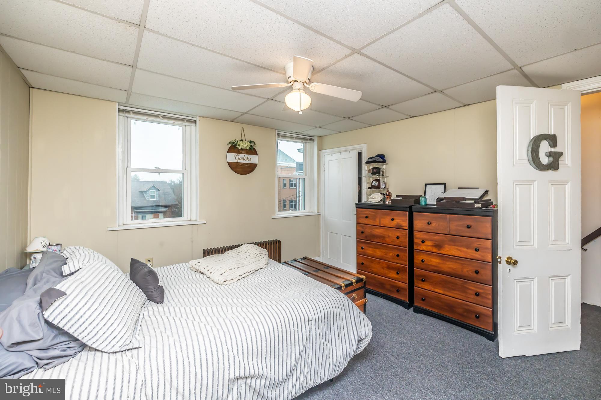 107 West State Street Kennett Square, PA 19348 - Photo 45 of 52 a bedroom with a bed and a dresser