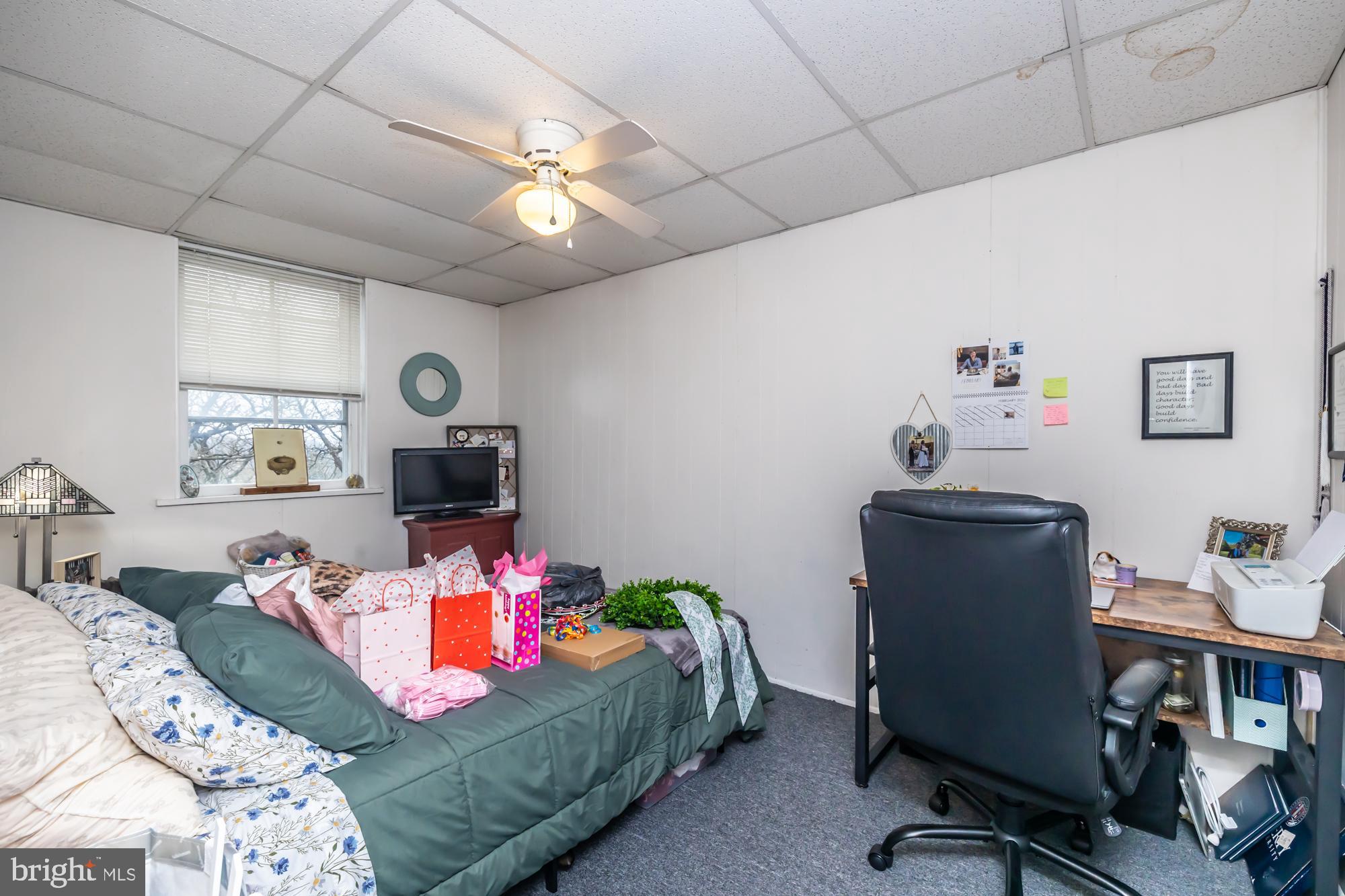 107 West State Street Kennett Square, PA 19348 - Photo 49 of 52 a bedroom with a bed and a chandelier
