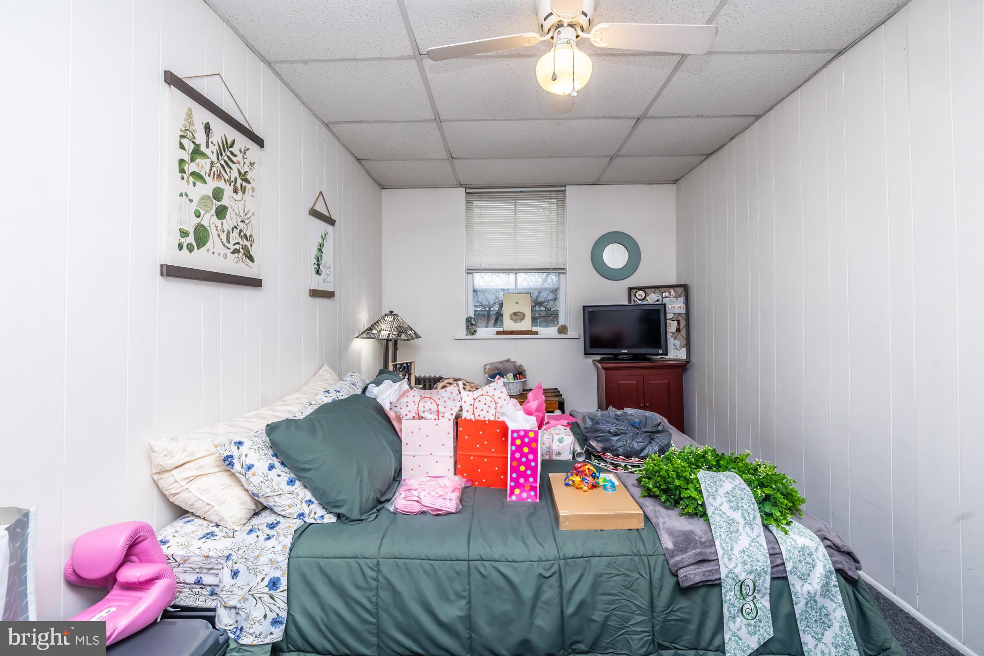 107 West State Street Kennett Square, PA 19348 - Photo 50 of 52 a bedroom with a bed and a chandelier
