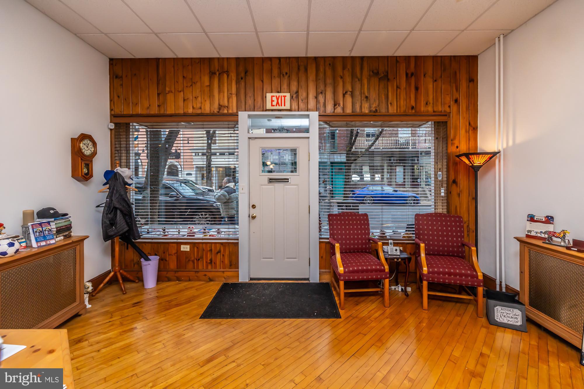 107 West State Street Kennett Square, PA 19348 - Photo 8 of 52 a living room with furniture and a dining table with kitchen view