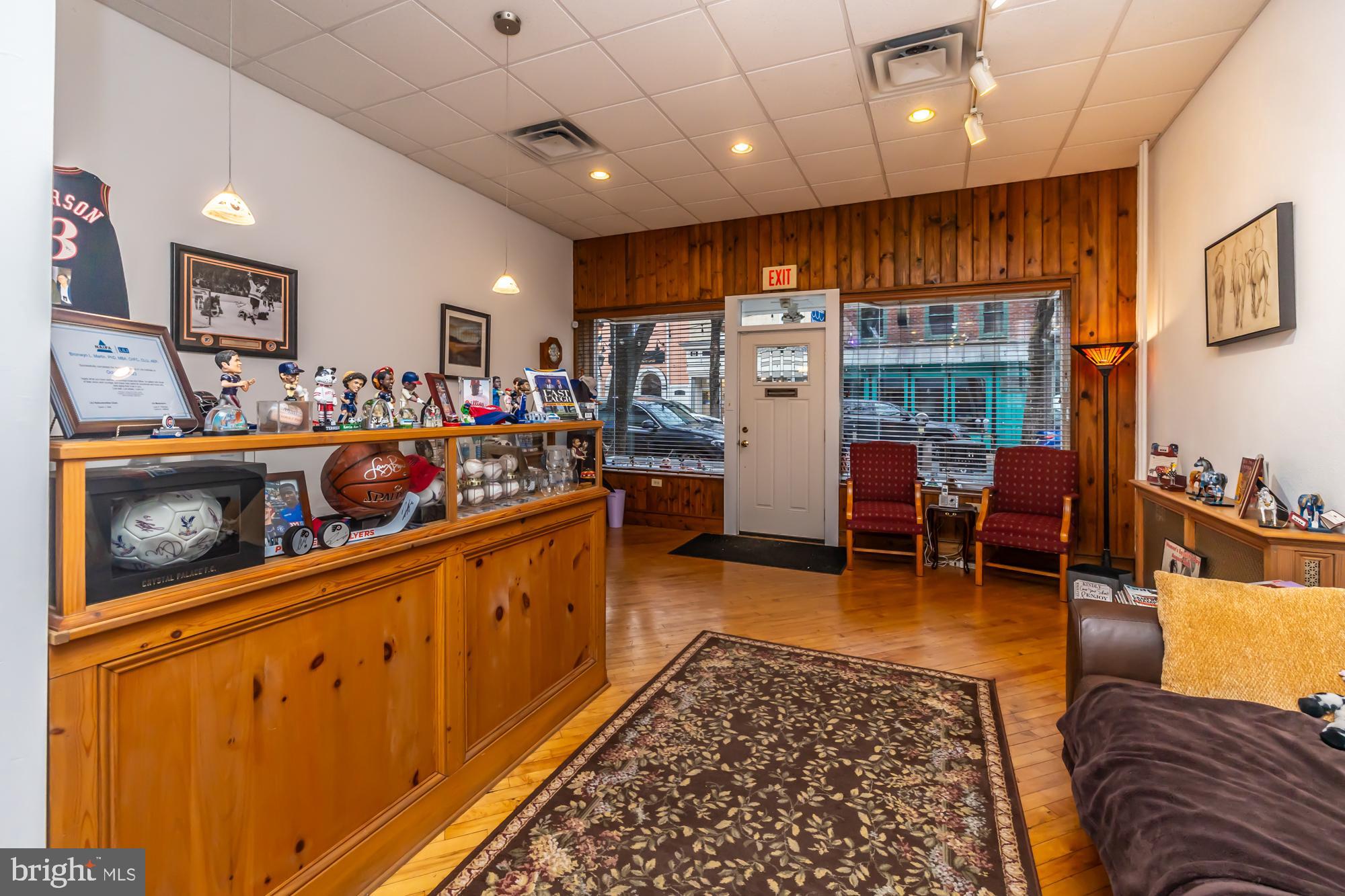 107 West State Street Kennett Square, PA 19348 - Photo 9 of 52 a large living room with stainless steel appliances kitchen island granite countertop furniture and a rug