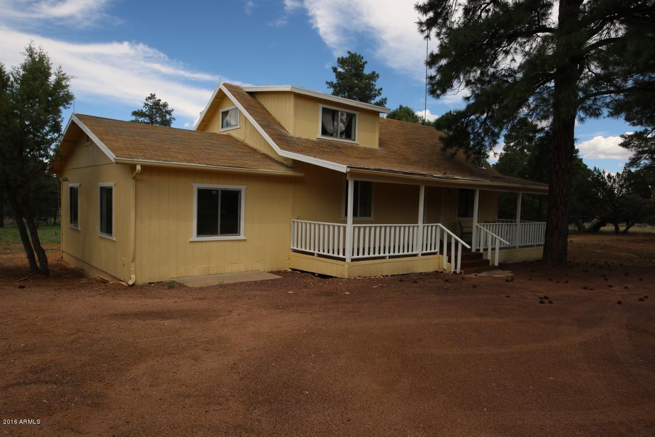 3070 Aspen Road Overgaard, AZ 85933 - Photo 1 of 38 a front view of a house with a garage