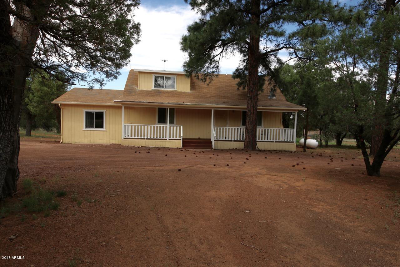 3070 Aspen Road Overgaard, AZ 85933 - Photo 3 of 38 a front view of a house with a tree