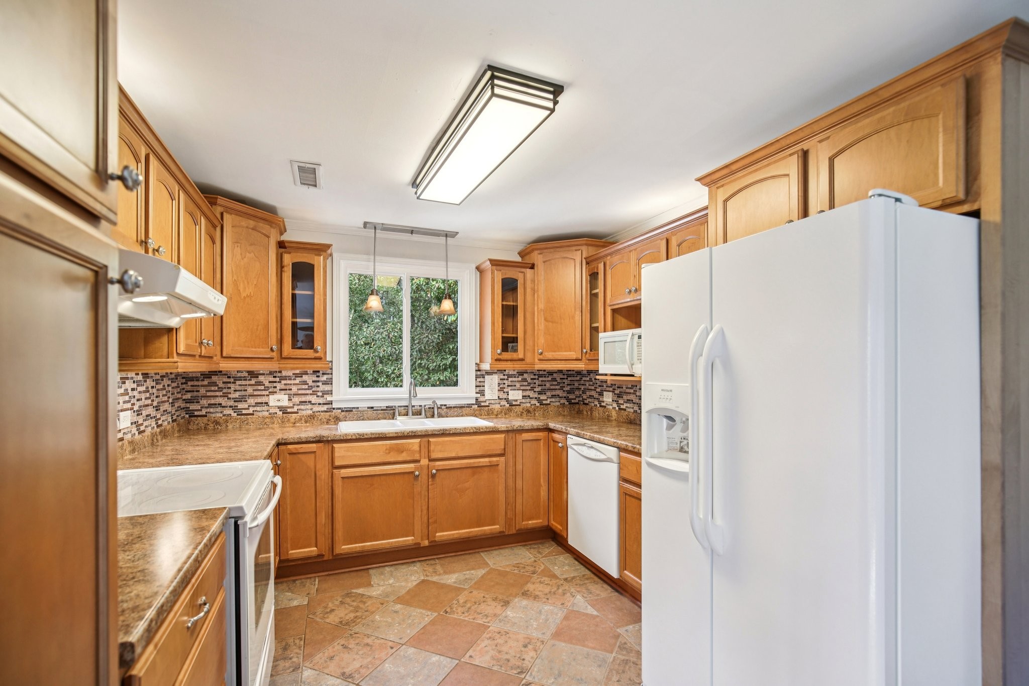 2411 Cloverdale Road Nashville, TN 37214 - Photo 12 of 33 a kitchen with a sink a refrigerator and cabinets