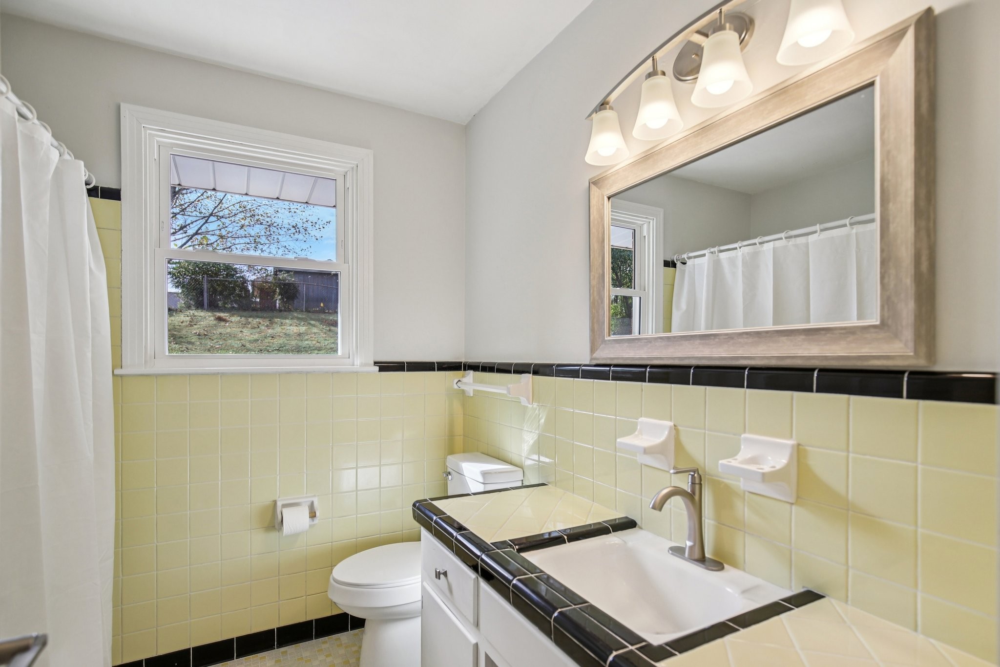 2411 Cloverdale Road Nashville, TN 37214 - Photo 14 of 33 a bathroom with a sink a toilet and a mirror