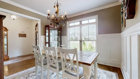 a view of a dining room with furniture and window