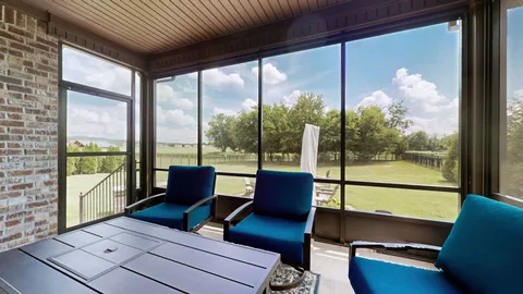 a living room with furniture and a floor to ceiling window