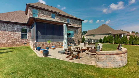 a view of a house with backyard sitting area and garden