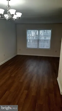 a view of a room with wooden floor and windows