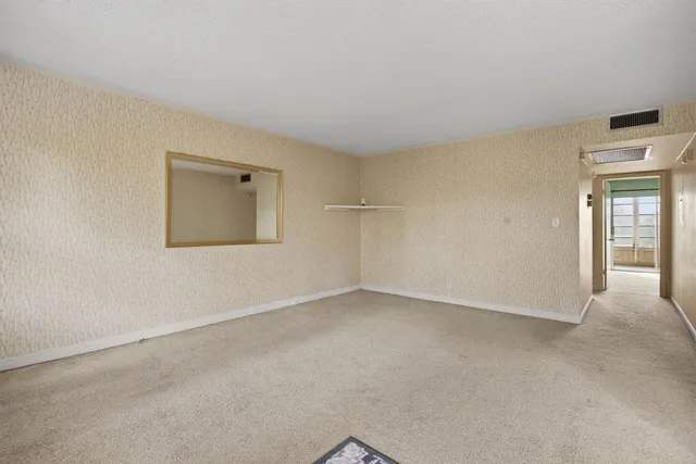 a view of a room with window and wooden floor