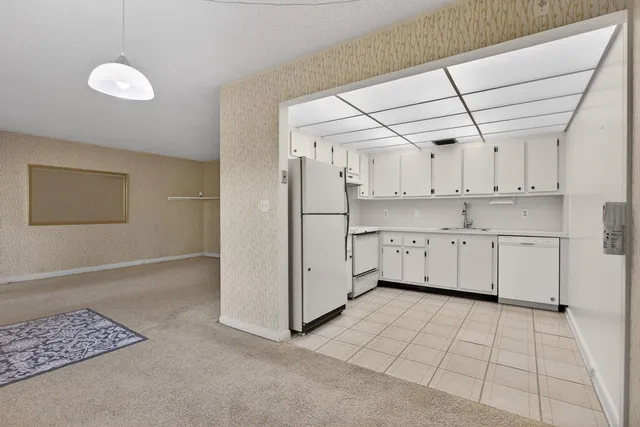a view of a kitchen with refrigerator and cabinet