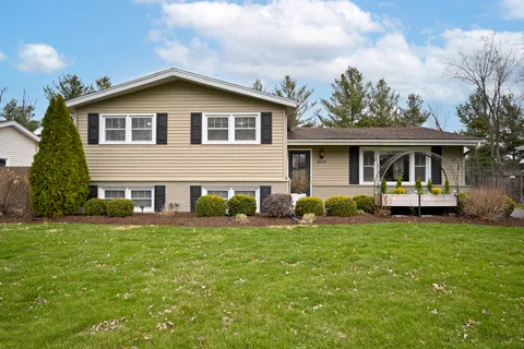 a front view of a house with a garden
