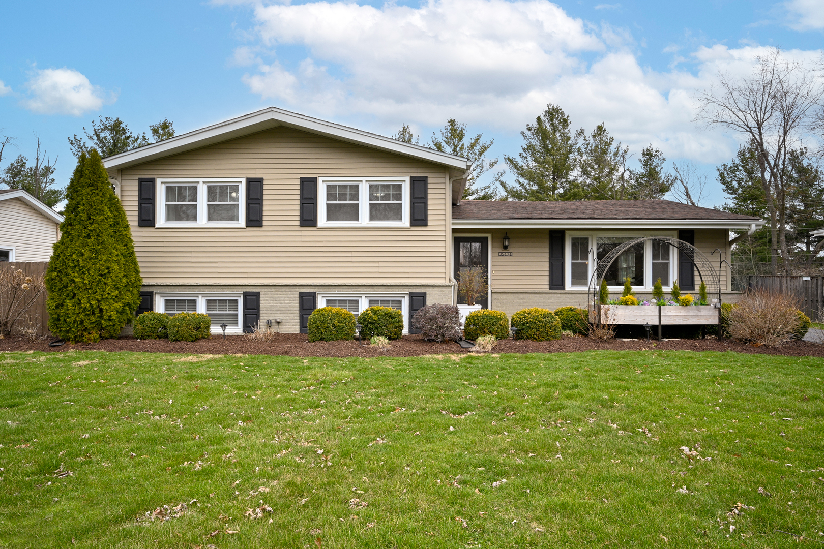 3S171 Arboretum Road Glen Ellyn, IL 60137 - Photo 1 of 41 a front view of a house with a garden
