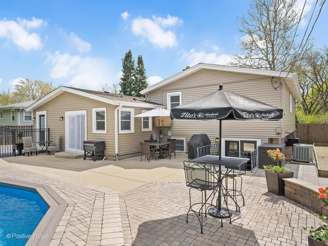 3S171 Arboretum Road Glen Ellyn, IL 60137 - Photo 34 of 41 a patio with a table and chairs and potted plants