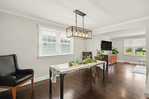 a view of a dining room with furniture window and wooden floor