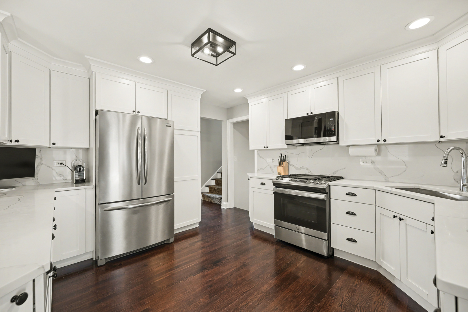 3S171 Arboretum Road Glen Ellyn, IL 60137 - Photo 9 of 41 a kitchen with stainless steel appliances white cabinets and wooden floor