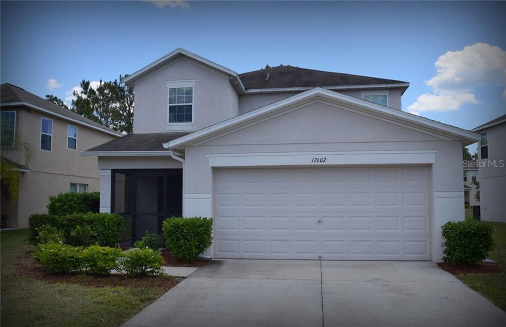 12602 White Bluff Road Hudson, FL 34669 - Photo 1 of 1 a front view of a house with a yard and garage