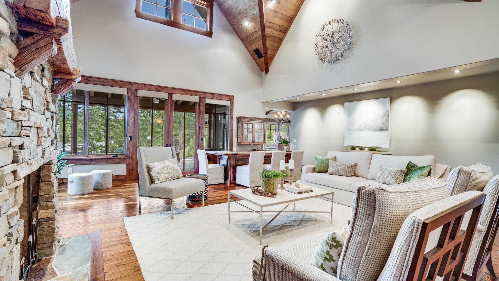 a living room with furniture fireplace and large windows