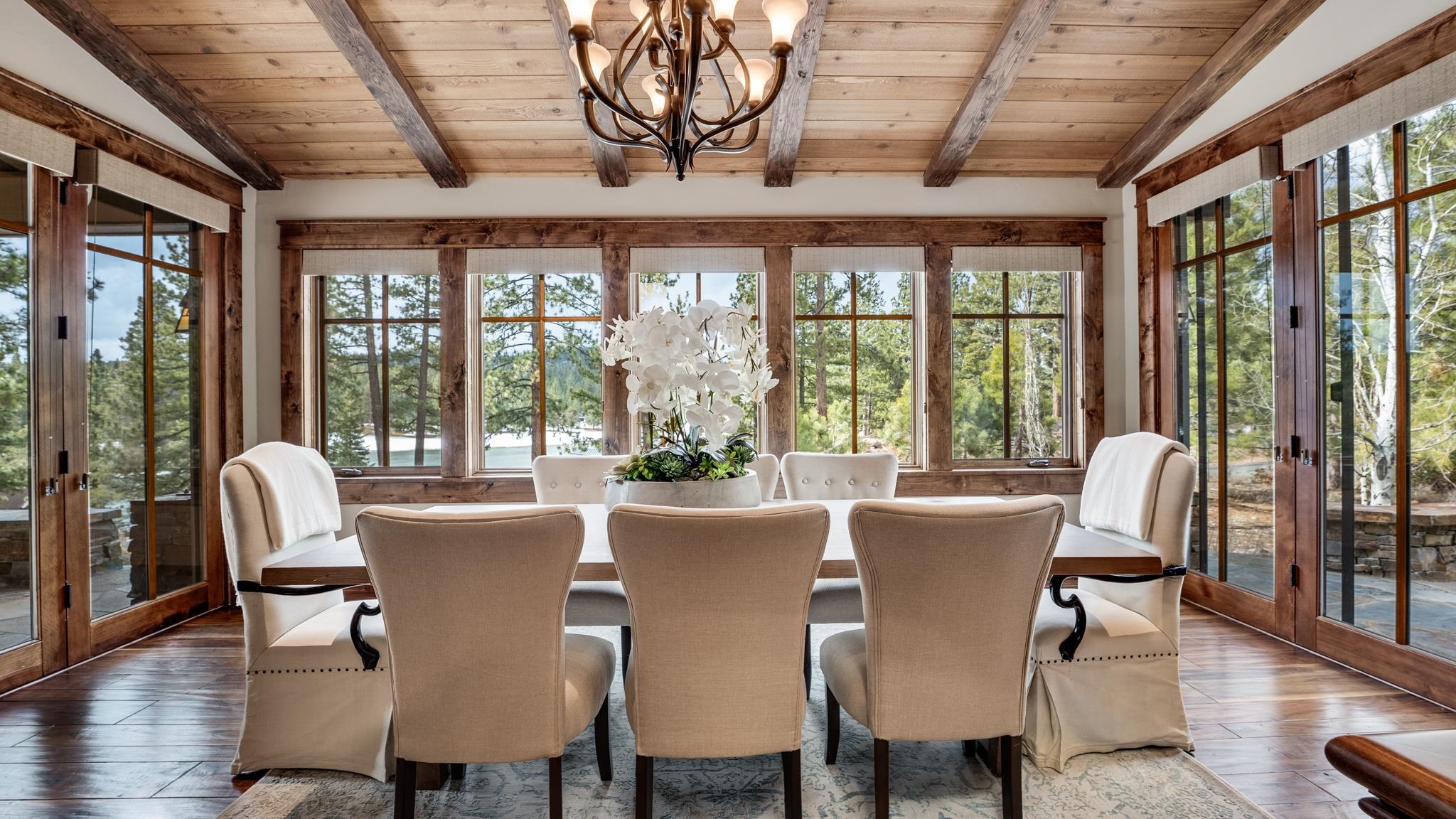8602 Lloyd Tevis Drive Truckee, CA 96161 - Photo 8 of 21 a view of a dining room with furniture large windows and wooden floor