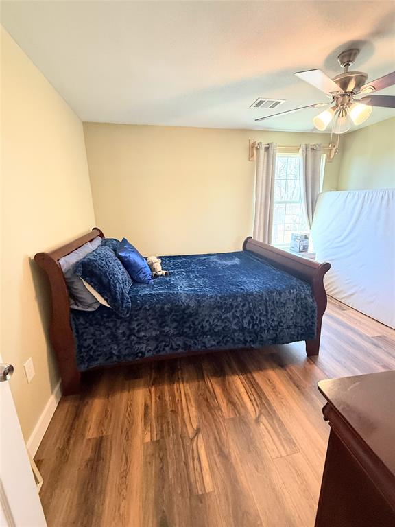 7838 Fm 937 Thornton, TX 76687 - Photo 17 of 30 a living room with a bed and a dresser with wooden floor