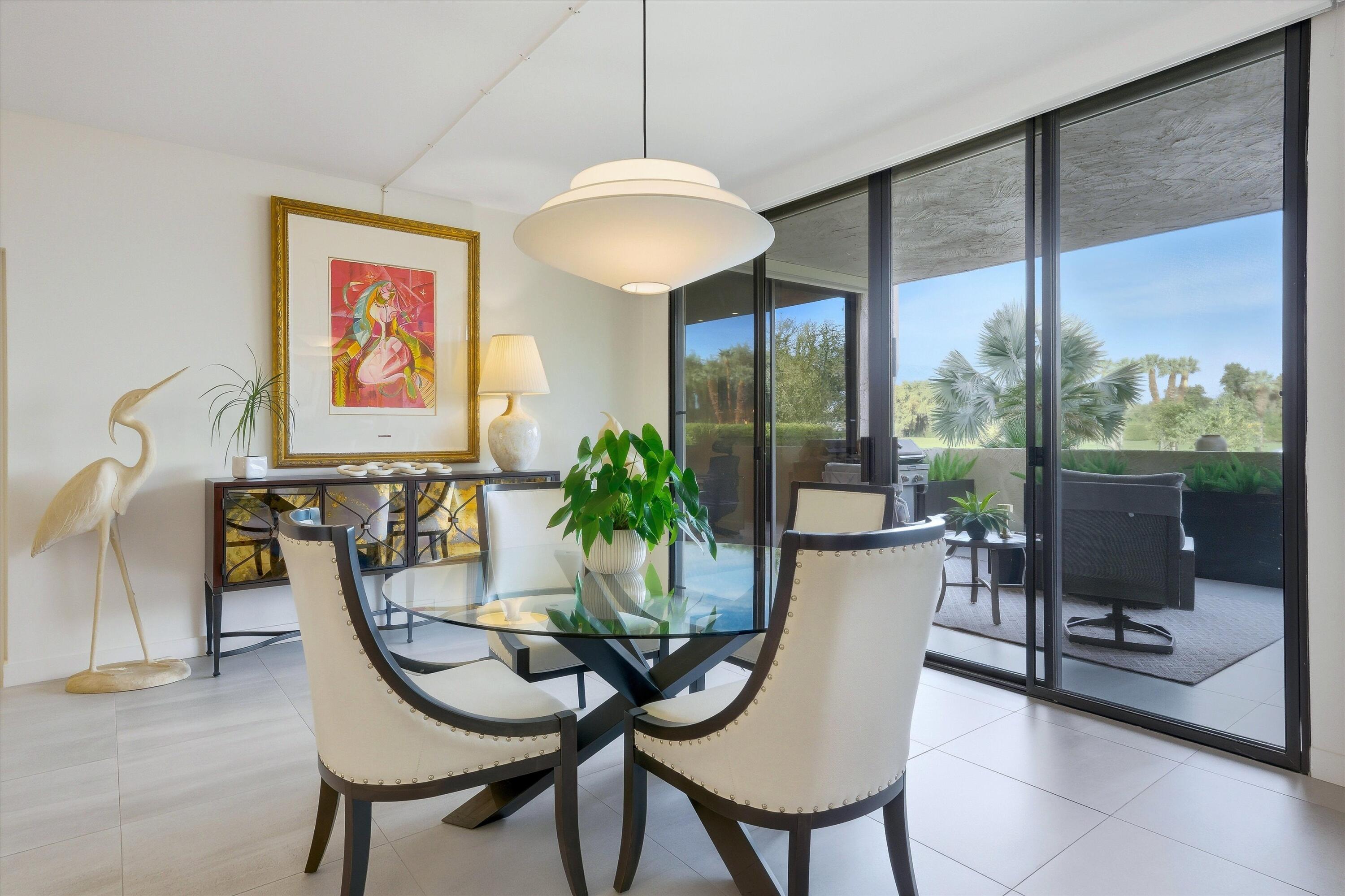910 Island Drive, Unit 110 Rancho Mirage, CA 92270 - Photo 12 of 30 a dining room with furniture and window