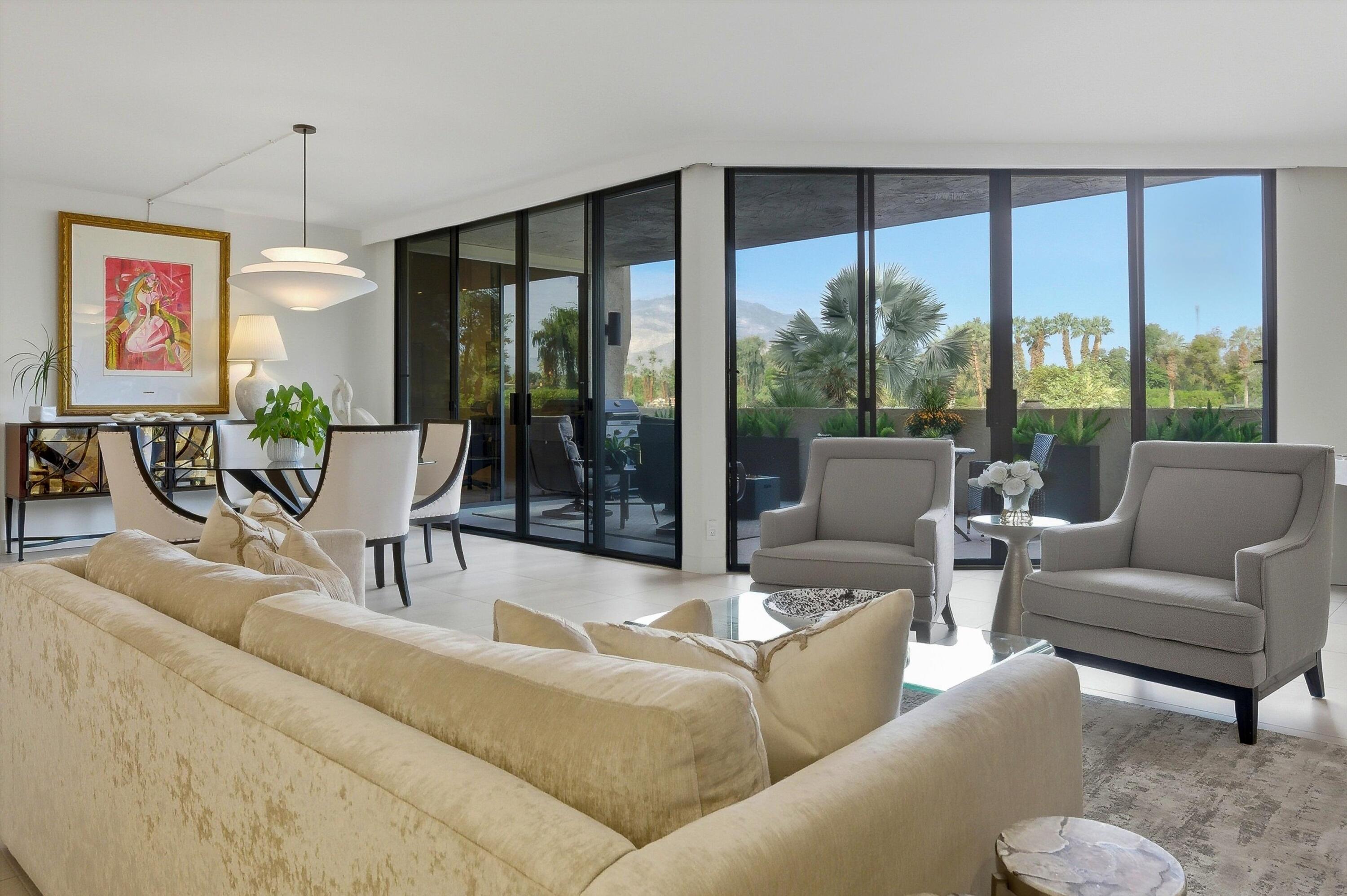 910 Island Drive, Unit 110 Rancho Mirage, CA 92270 - Photo 14 of 30 a living room with furniture and a large window