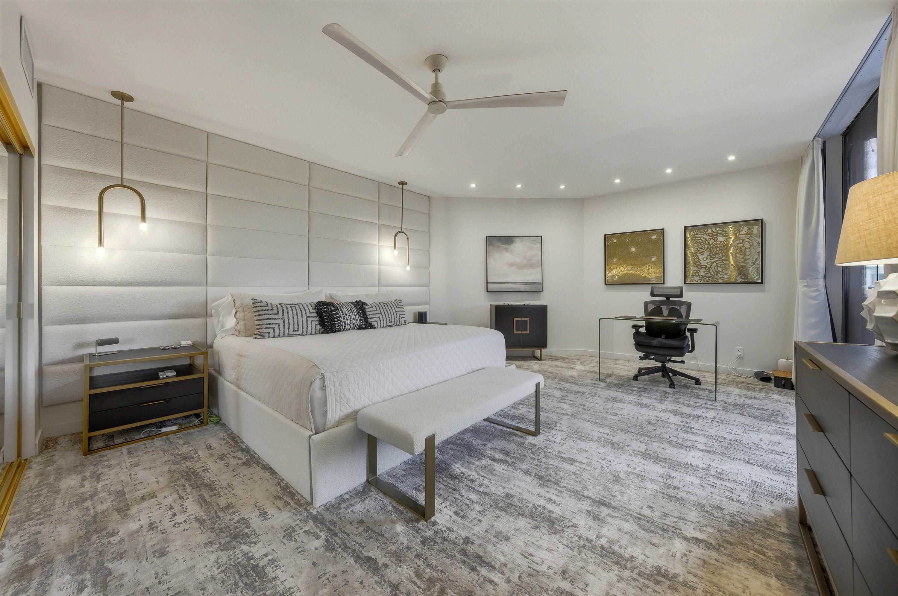 910 Island Drive, Unit 110 Rancho Mirage, CA 92270 - Photo 19 of 30 a large bedroom with a bed a table and chair