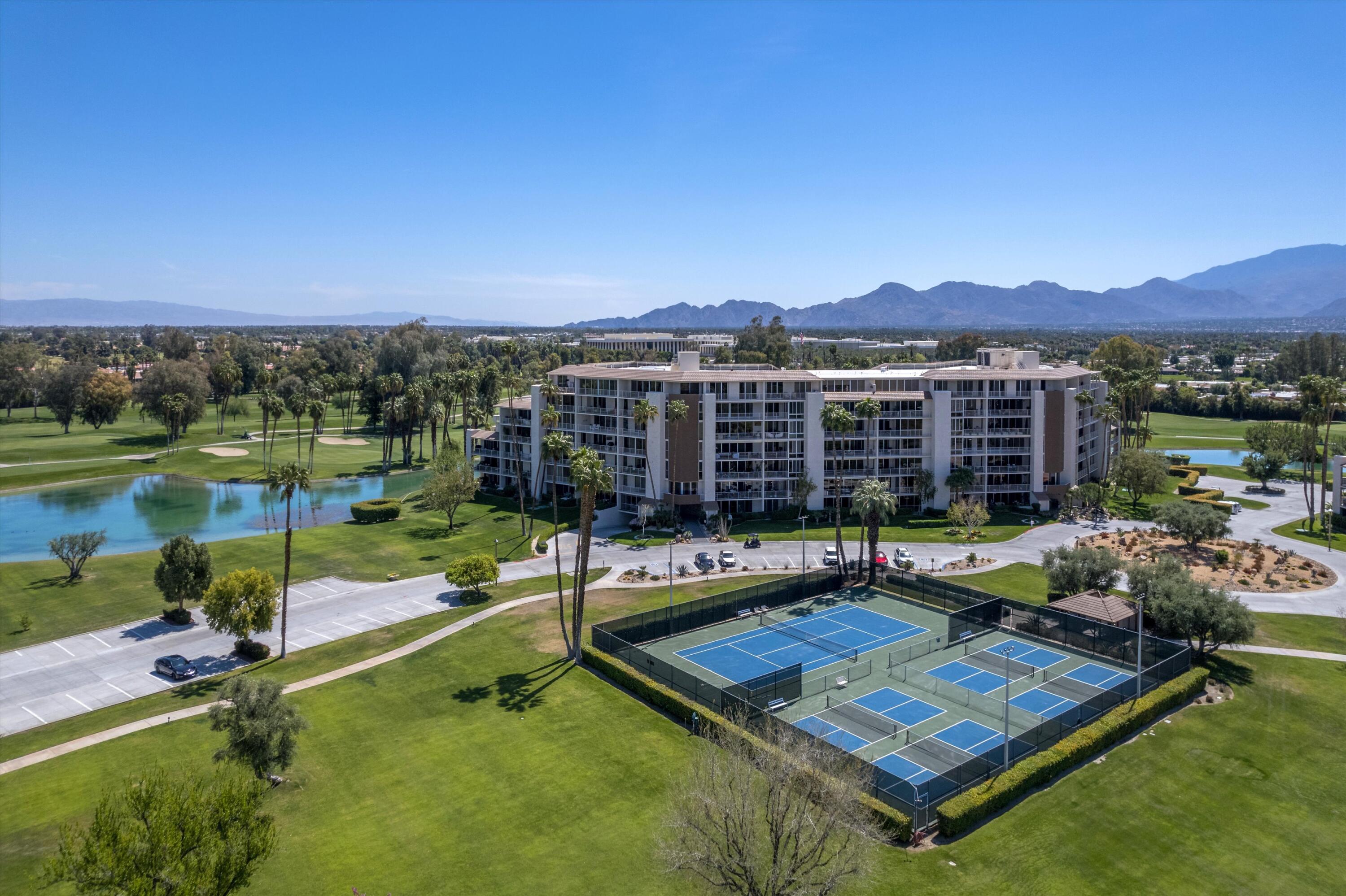 910 Island Drive, Unit 110 Rancho Mirage, CA 92270 - Photo 28 of 30 a view of a house with swimming pool and a yard