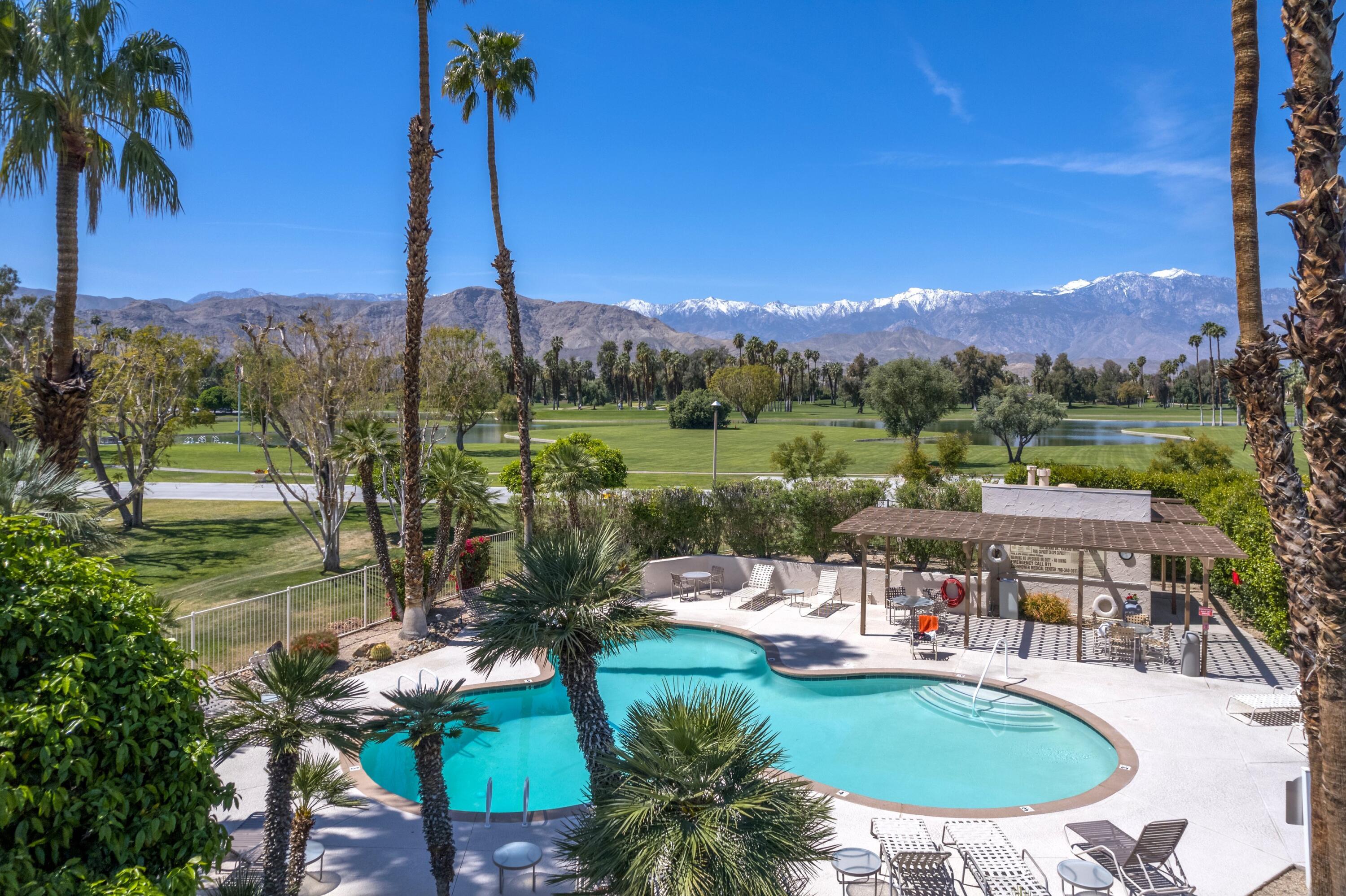 910 Island Drive, Unit 110 Rancho Mirage, CA 92270 - Photo 30 of 30 a view of a swimming pool and a chairs