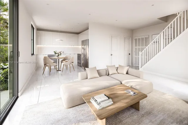 a living room with furniture and a dining table with garden view