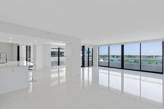 a view of a living room hardwood floor and a large window