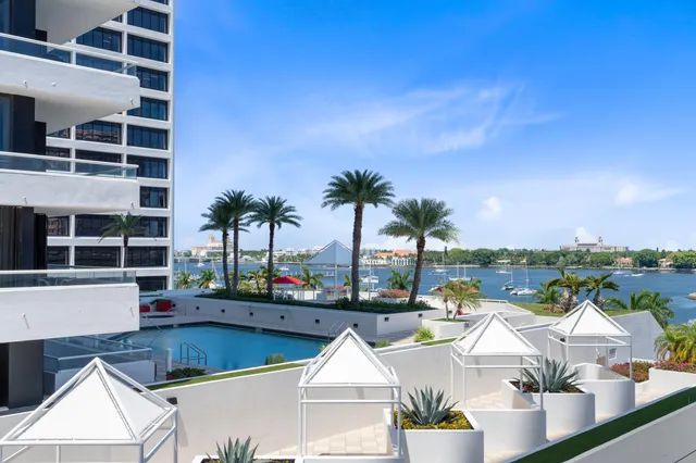 a view of swimming pool with outdoor seating and city view