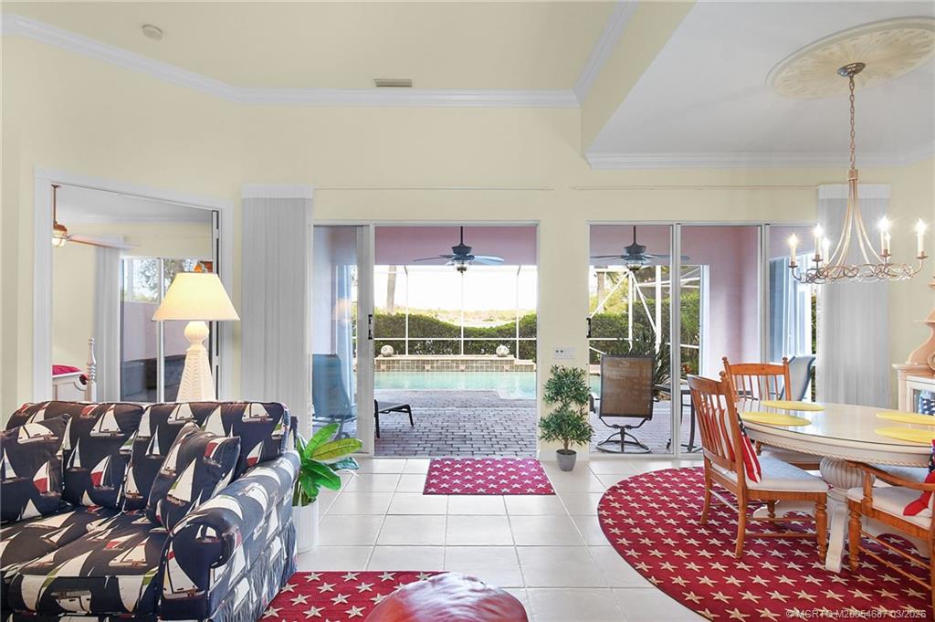 1541 Southwest Balmoral Trace Stuart, FL 34997 - Photo 13 of 52 a living room with furniture and a chandelier