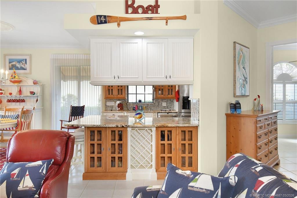 1541 Southwest Balmoral Trace Stuart, FL 34997 - Photo 16 of 52 a living room with stainless steel appliances furniture a rug and a dining table