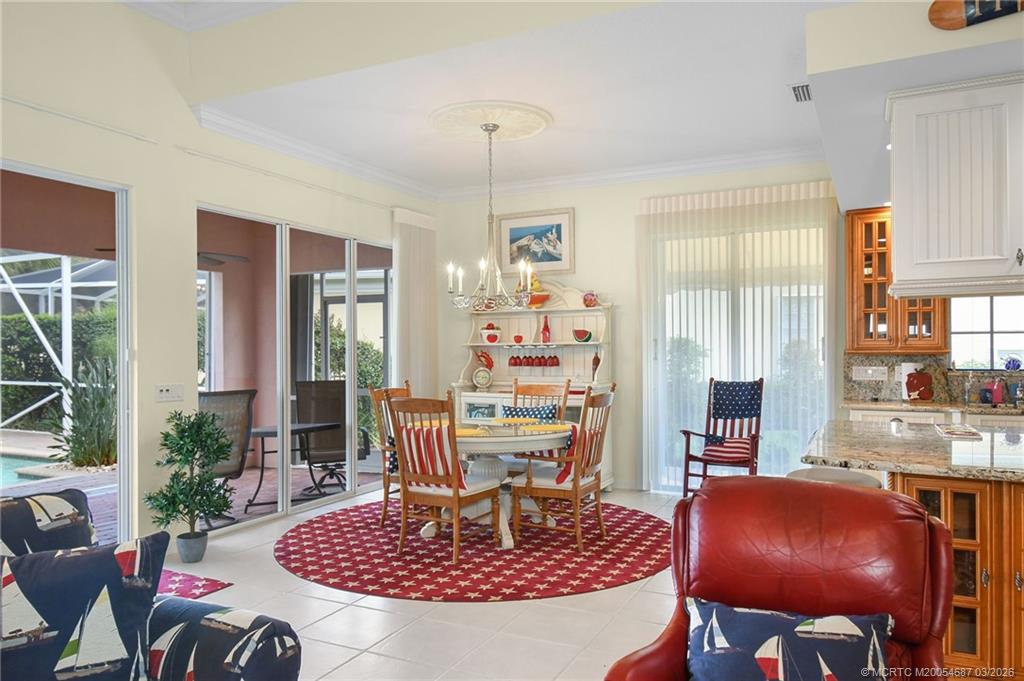 1541 Southwest Balmoral Trace Stuart, FL 34997 - Photo 17 of 52 a living room with furniture and a chandelier