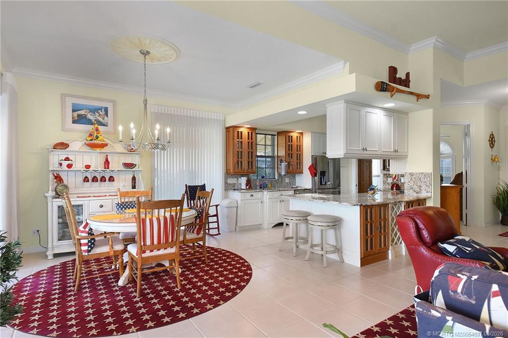 1541 Southwest Balmoral Trace Stuart, FL 34997 - Photo 18 of 52 a large kitchen with a table and chairs