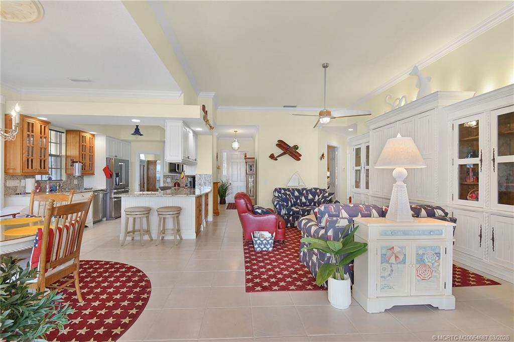 1541 Southwest Balmoral Trace Stuart, FL 34997 - Photo 19 of 52 a living room with furniture and a chandelier