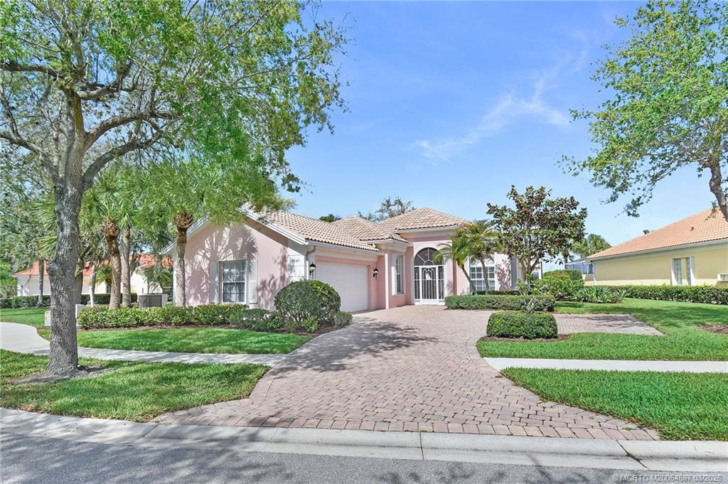 1541 Southwest Balmoral Trace Stuart, FL 34997 - Photo 2 of 52 front view of a house with a yard