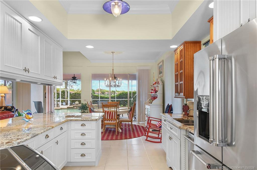 1541 Southwest Balmoral Trace Stuart, FL 34997 - Photo 25 of 52 a kitchen with counter top space cabinets and outdoor view