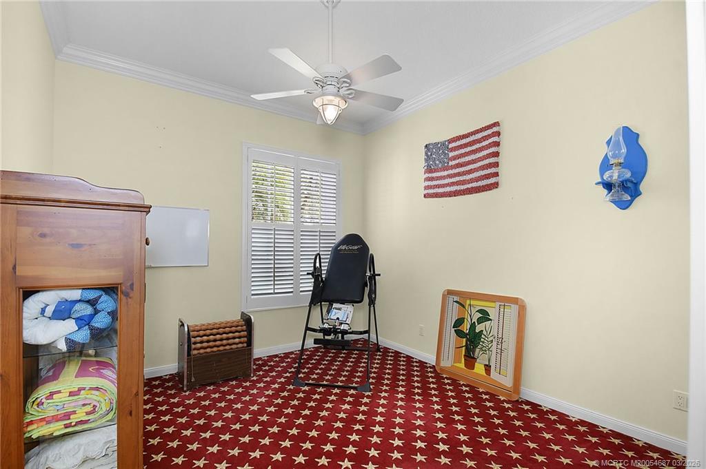 1541 Southwest Balmoral Trace Stuart, FL 34997 - Photo 41 of 52 a bedroom with a bed and a table