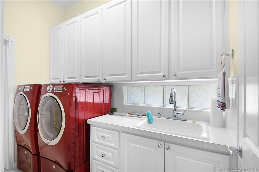 1541 Southwest Balmoral Trace Stuart, FL 34997 - Photo 42 of 52 a utility room with a sink a washer and dryer
