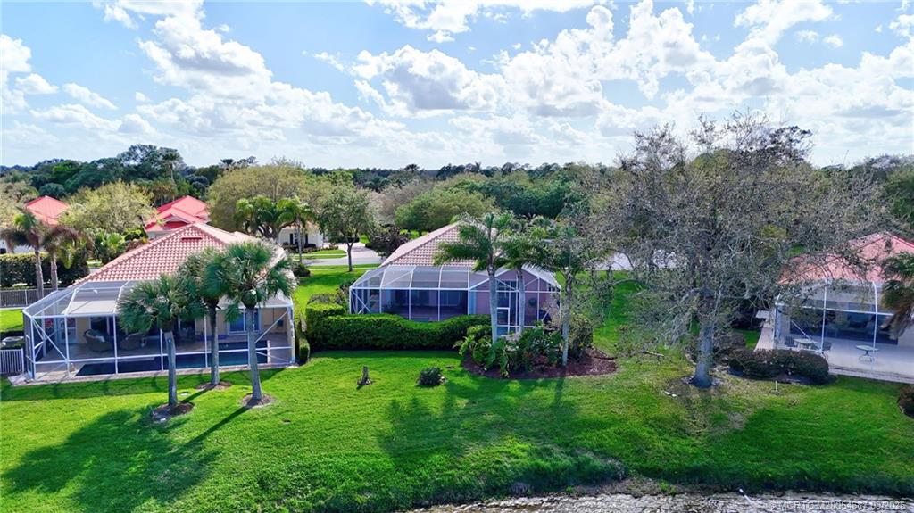 1541 Southwest Balmoral Trace Stuart, FL 34997 - Photo 48 of 52 a view of a garden with a house in the background