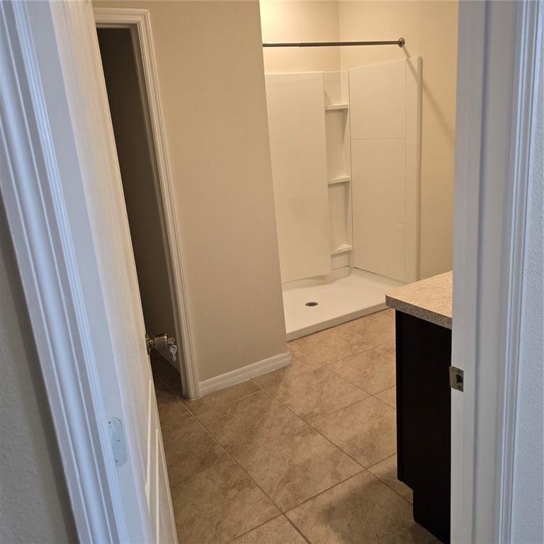 814 Sun Burst Road Winter Haven, FL 33880 - Photo 23 of 48 a bathroom with a shower and a door